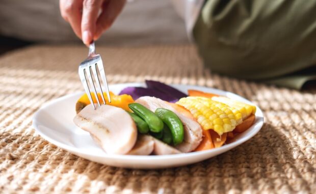 closeup image of a woman eating vegetables, vegan, clean food, dieting concept