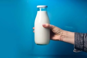 women holding a bottle of low fat milk