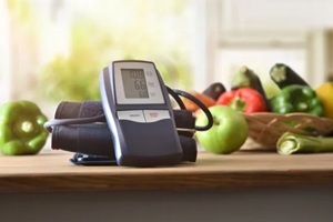 blood pressure monitor with fruits in background