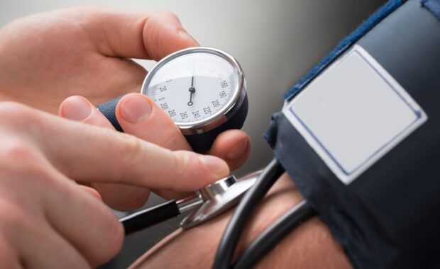 NC doctor checking hypertension blood pressure of a patient