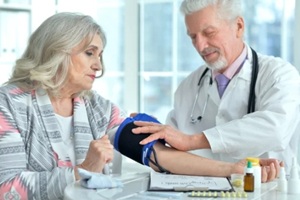 Durham, NC doctor checking blood pressure of an old lady