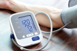 man check blood pressure monitor and heart rate monitor with digital pressure gauge