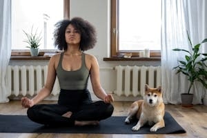 Girl Doing Meditation Besides Her Dog practicing high blood pressure stress management morning routine