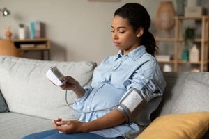 african american lady measuring blood pressure having low tension problem