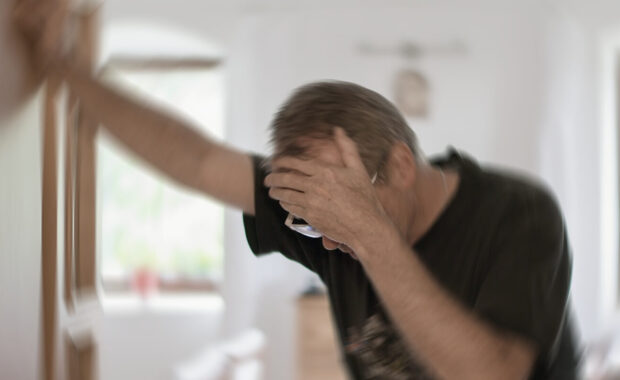 man suffering from vertigo or dizziness or other health problem of brain or inner ear