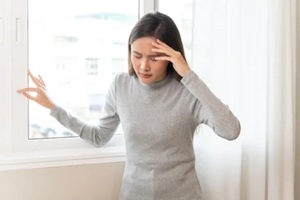 young asian females feeling dizzy after standing too fast