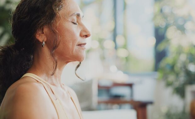 calm woman, meditation and home with breathing exercise for spiritual wellness or health