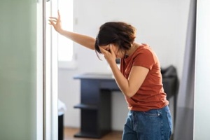 middle eastern woman feeling unwell at home