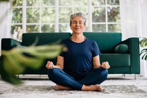 senior woman meditating at home