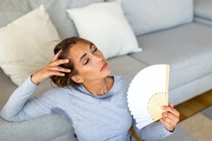 young woman sweating at home