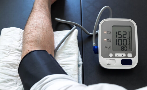 hypertensive patient performing a blood pressure auto test