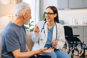 doctor visiting senior man at home discussing healthcare